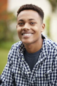 young black man outdoors smiles to camera close up vertical 144591747